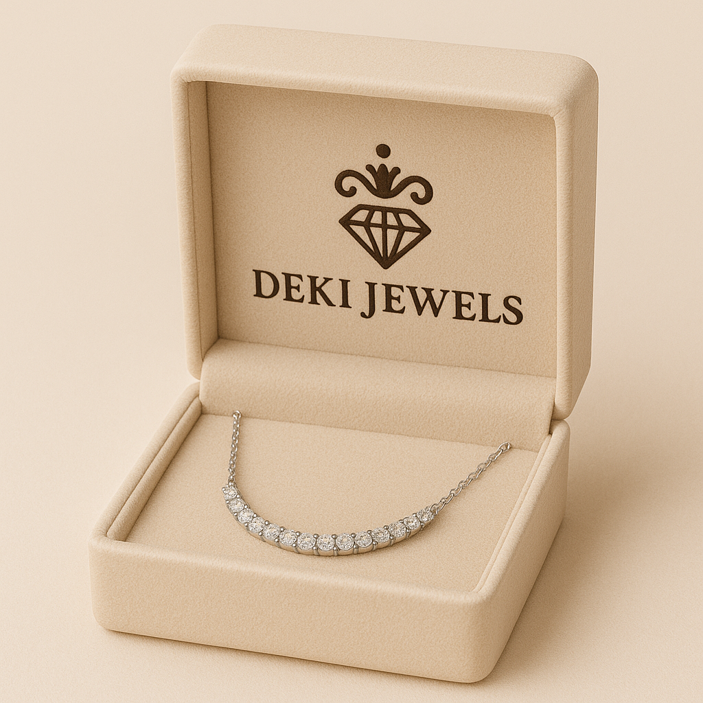 Silver necklace in a 'DEKI JEWELS' box on a beige background